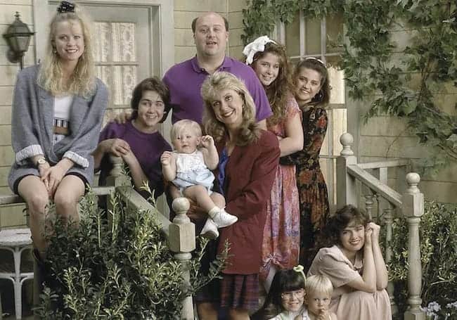 Cast of "Just the Ten of Us" posing on a porch.