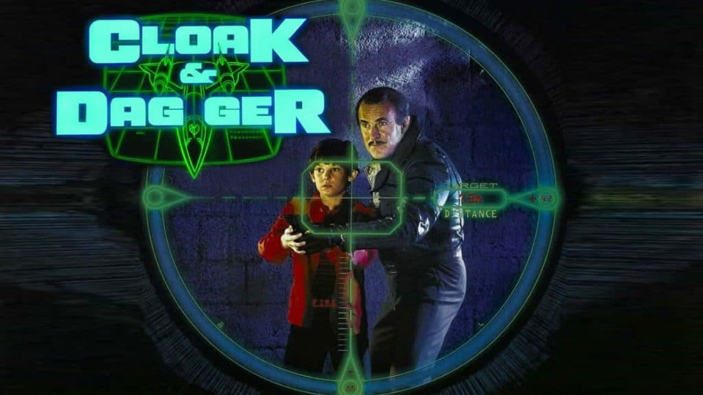 Box artwork for the 1984 movie "Cloak & Dagger" featuring a young boy and an older man in a targeting scope.